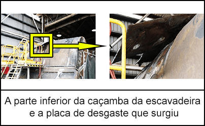 A parte inferior da caçamba da escavadeira e a placa de desgaste que surgiu