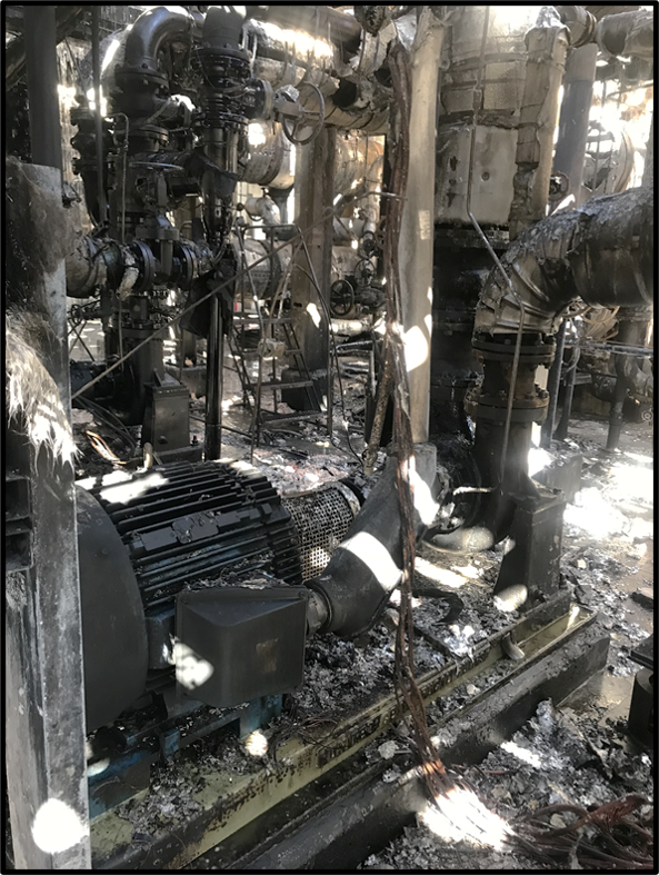 The fire damaged pump. The surrounding equipment has significant fire damage. 