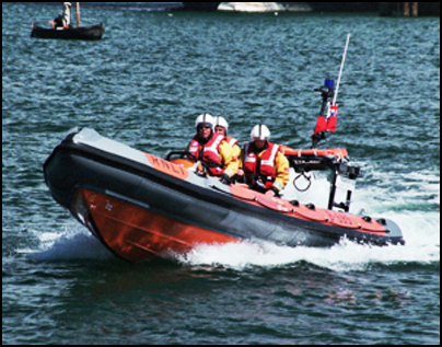 Image of a crew wearing high visibility vests onboard a fast rescue craft