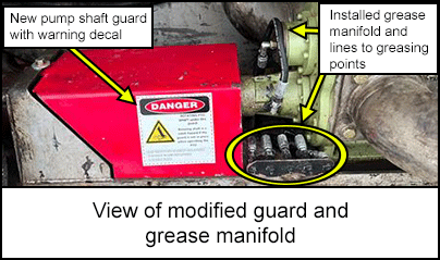 View of modified guard and grease manifold 