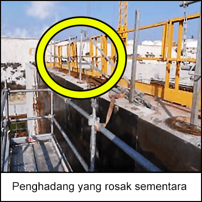 Penghadang yang rosak sementara diletakkan di atas jatuhan. Perancah terletak bersebelahan penghadang.