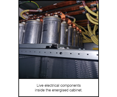 Live electrical components inside the energised cabinet.