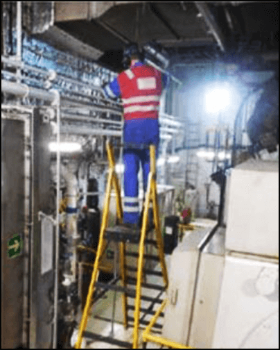 Engineer working at height on a stepladder platform