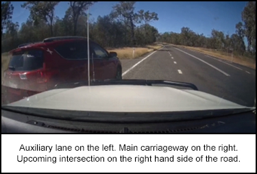 1128-s1.png Auxiliary lane on the left. Main carriageway on the right. Upcoming intersection on the right hand side of the road.