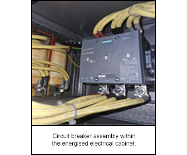 Circuit breaker assembly within the energised electrical cabinet.