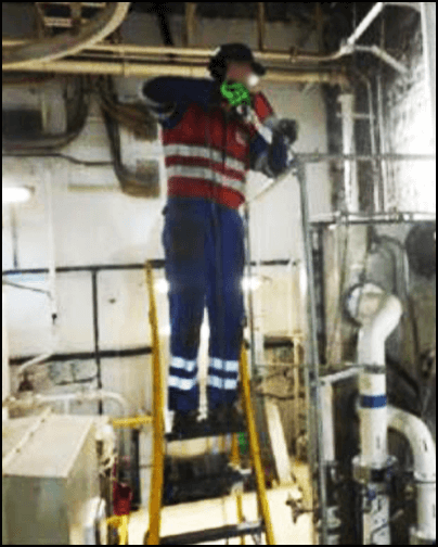 Engineer using a power drill while working at height