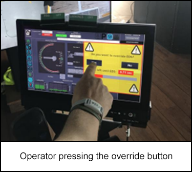 Operator pressing the override button 