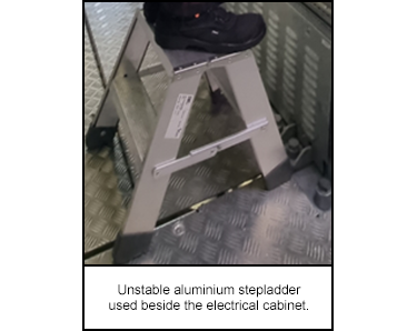 Unstable aluminium stepladder used beside the electrical cabinet.