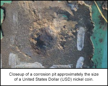 Closeup of a corrosion pit approximately the size of a United States Dollar (USD) nickel coin.