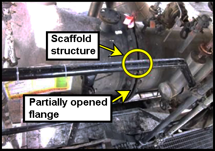 The scaffold structure located next to the partially opened flange.