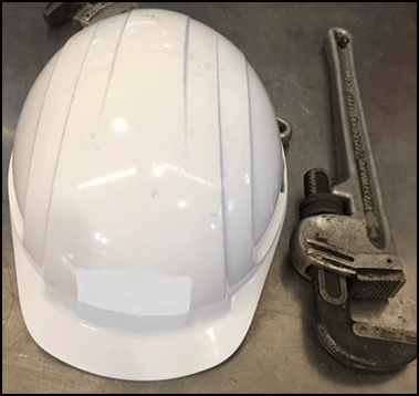 Helmet and pipe wrench