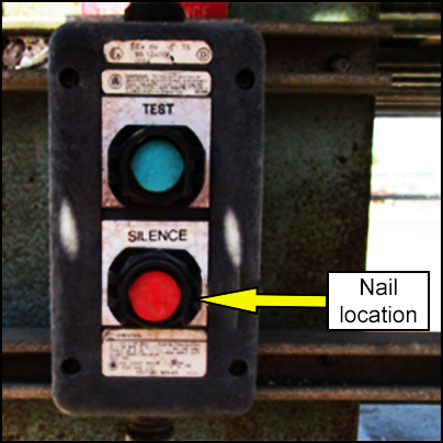 Location of nail jammed into the silence button of alarm system