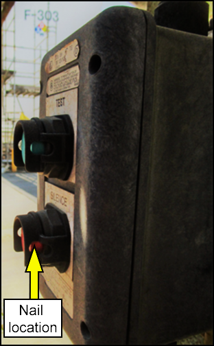 Location of nail jammed into the silence button of alarm system (side view)