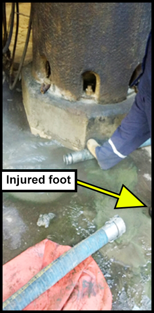 The unplugged 3 inch hose. The operators right foot is holding the open end of the hose. 