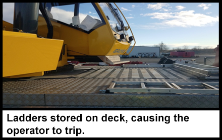 Three ladders lying flat on the deck of the crane next to the operator.