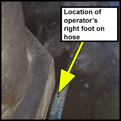 The open end of the hose where the operator put their right foot. 