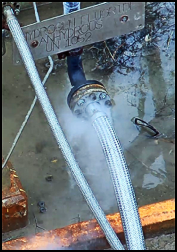 Hydrogen fluoride vapour leaking from a hose that is connected to a nozzle.