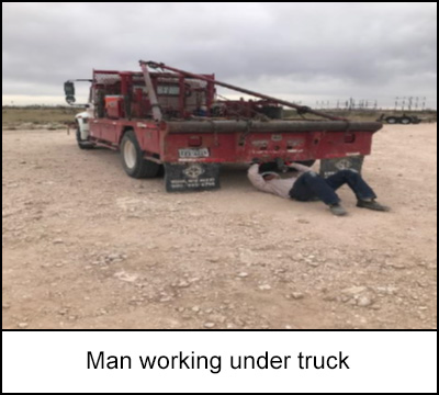 Man working under truck