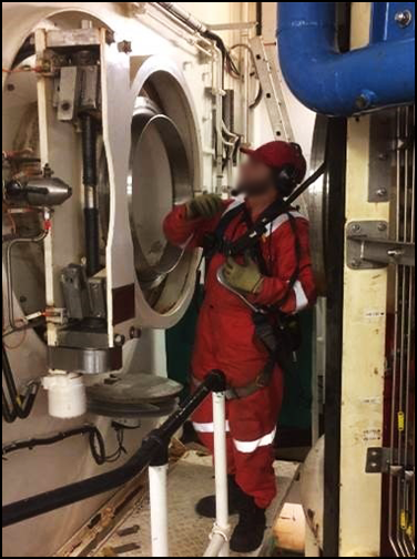 A worker examining the diving support vessel 