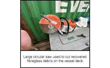 Large circular saw used to cut recovered fibreglass debris on the vessel deck.