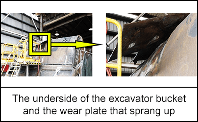 The underside of the excavator bucket and the wear plate that sprang up