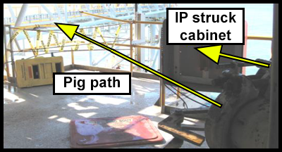 An opened pig trap door and a yellow arrow showing the direction the door travelled across the deck. 