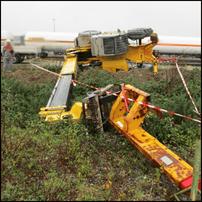 A fallen crane lying on its side in a field. The crane is cordoned off with tape.