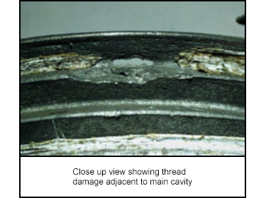 Close up view showing thread damage adjacent to main cavity