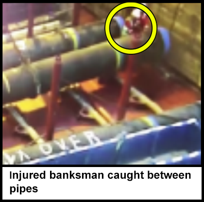 The banksman caught between two large pipes. 